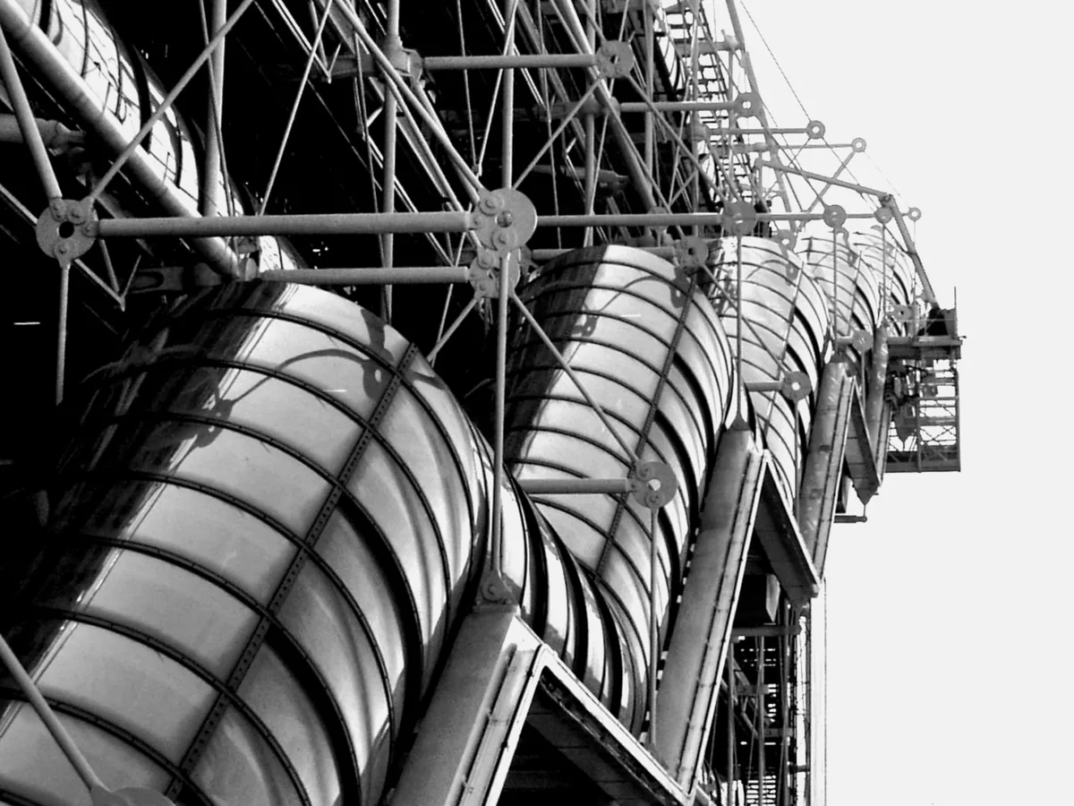 Steel scaffold of external stairs against a white sky