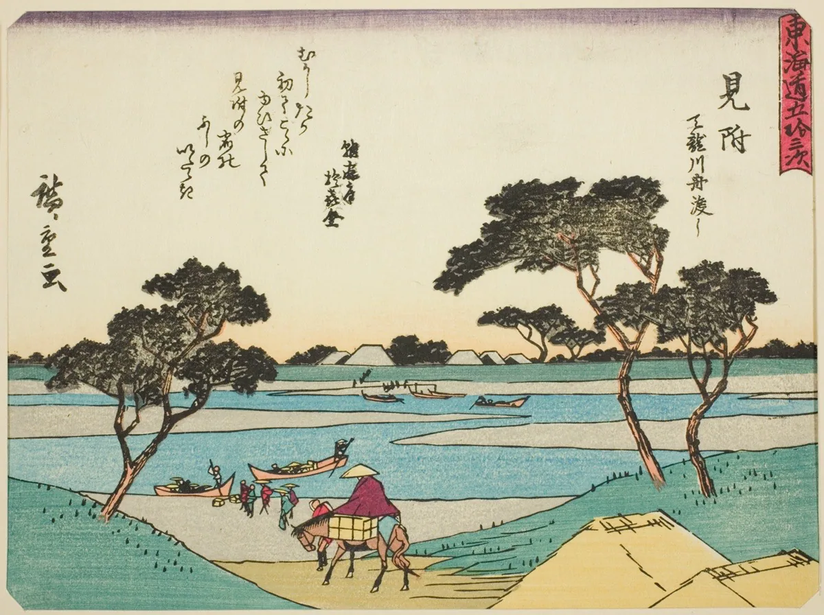 Color print of a Japanese landscape with a person on horseback in the foreground, flanked by several trees and low green hills. Beyond this figure, others on ferries cross a winding river in rowboats toward tent-like structures in the distance. Vertical text in Japanese peppers the top half of the work, with text in a vertical red banner at upper right.