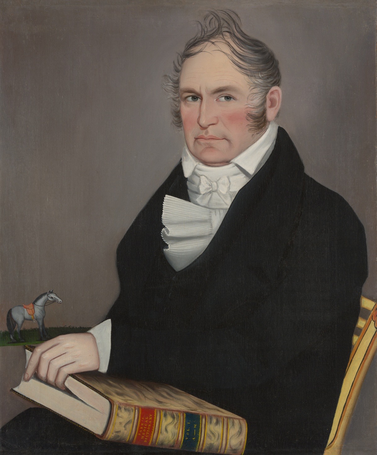 Portrait of man, black coat, white collar, hand in book.