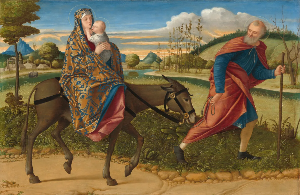Close to us, a bearded, balding man leads a donkey carrying a woman and child to our right against a hilly landscape in this horizontal painting.
