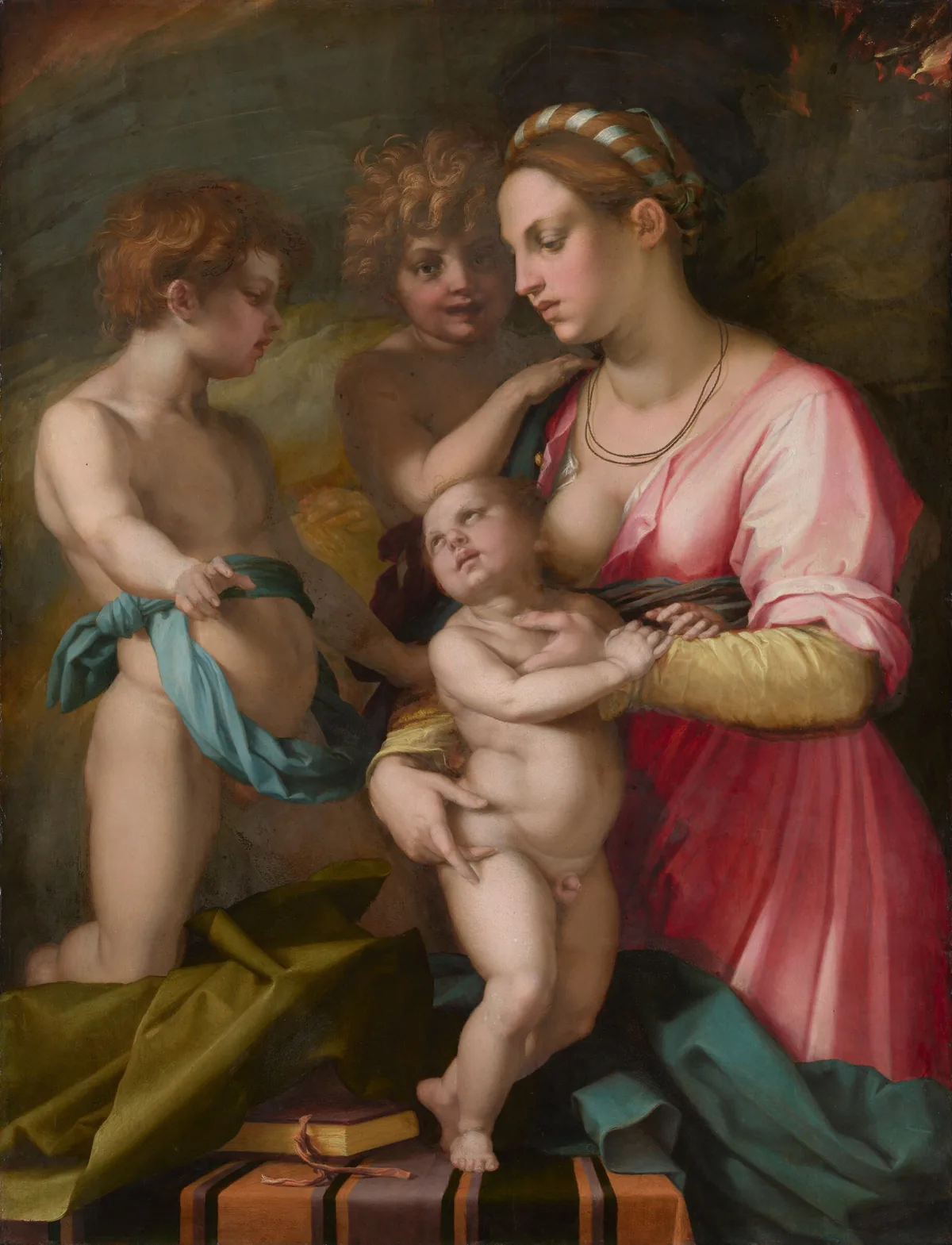 Two nude young boys and a young woman holding a standing infant are tightly grouped around a table, almost filling this vertical painting.