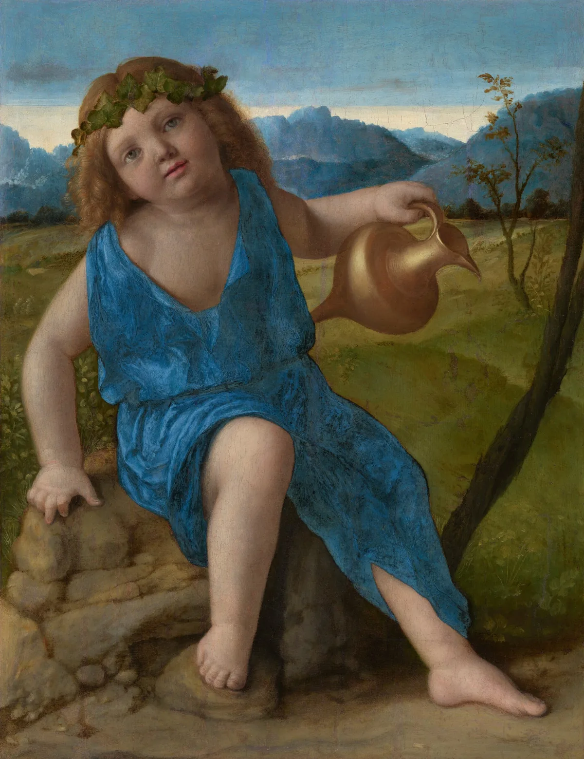 A young, pale-skinned boy wearing a brilliant blue toga sits on a rock and holds a gold pitcher in a landscape in this vertical painting.