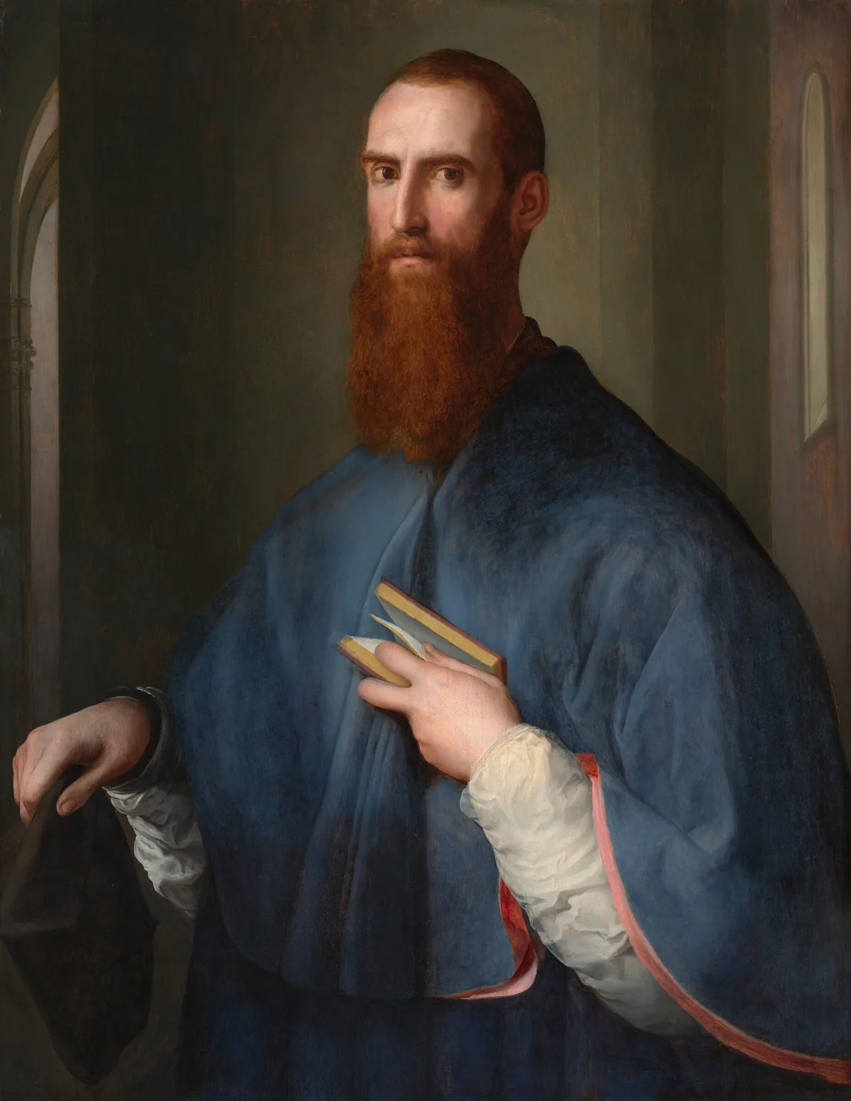 A  light-skinned man with short, auburn-brown hair and a long beard is shown from the hips up, his chest and sloping shoulders covered by a muted cobalt-blue cape in this vertical portrait painting.