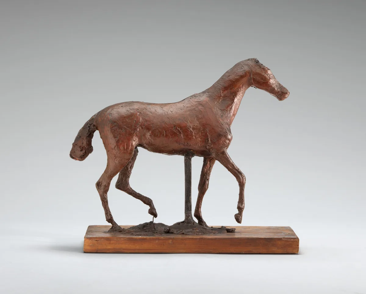 The sculpture depicts a horse in a pose suggesting movement.