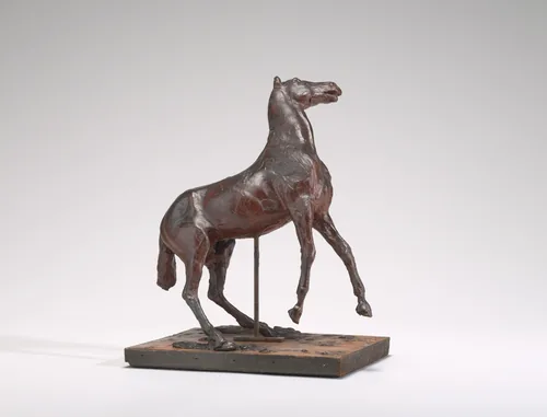The sculpture depicts a horse with its front legs lifted and angled as if in motion.