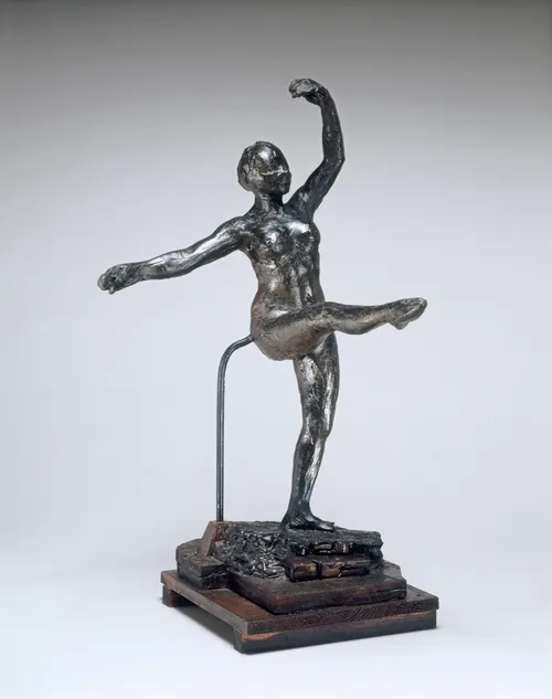 The sculpture shows a dancer in mid-motion with one leg raised, one arm lifted above the head, and the other arm extended to the side.
