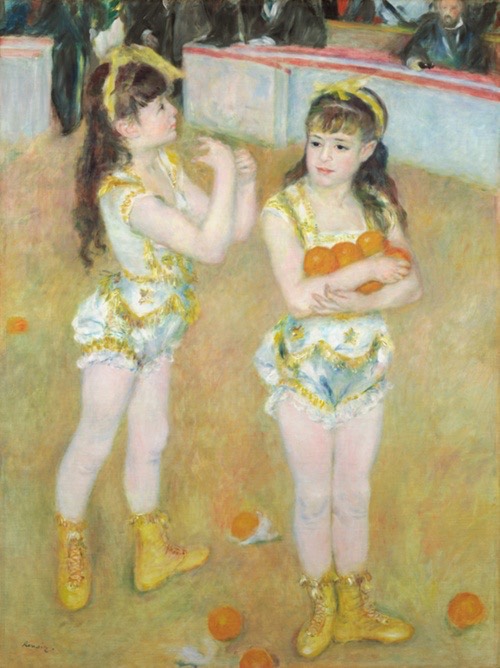 Two girls in acrobatic uniforms stand in an arena, one holds oranges.