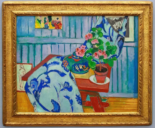 Still life of geranium plant, fruit, water pitcher, and two cats.