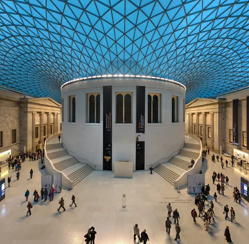 The glass and steel lattice roof of the Great Court curving around the circular Reading Room.