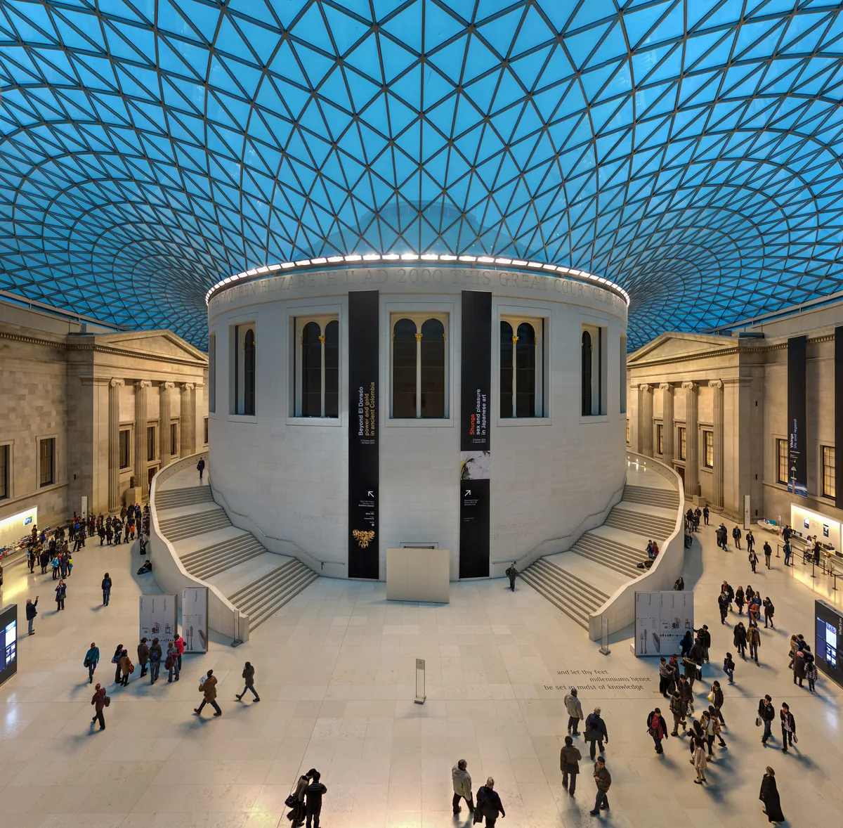 The glass and steel lattice roof of the Great Court curving around the circular Reading Room.
