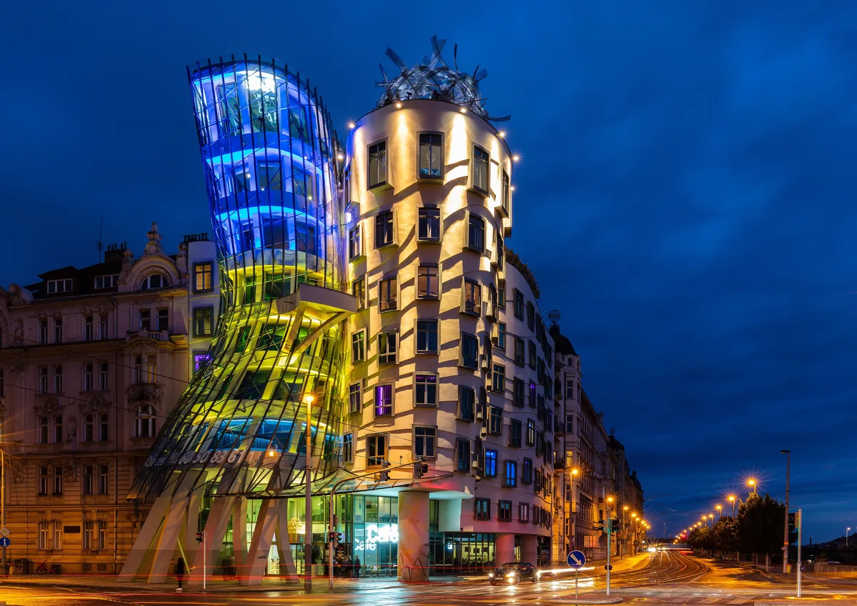 The Dancing House leaning into its neighbour on the Vltava embankment.