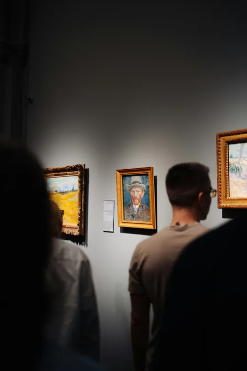 Visitors pause before Van Gogh’s self-portraits at the Van Gogh Museum.