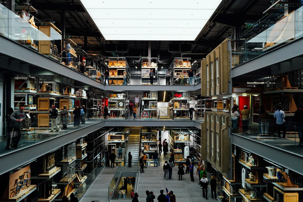 Open storage at the V&A East Storehouse, thousands of objects visible on catwalks between the shelves.