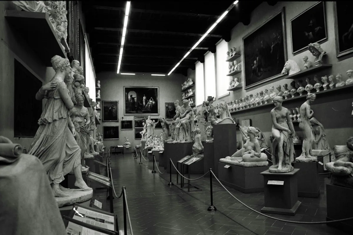 Plaster casts and marble figures crowd a sculpture hall at the Uffizi.