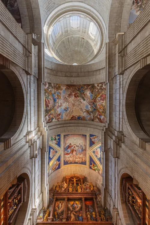 The nave of the basilica at El Escorial rising to its painted dome, the gilded altarpiece at the far end.